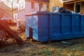 Loading the garbage container old and used construction material in the new building construction work site