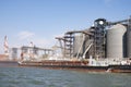 Loading grain on a ship in the port. View from the river to the port infrastructure, grain storage terminals