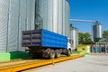 Loading grain by trucks onto the elevator into metal containers Royalty Free Stock Photo