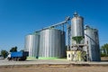 Loading grain by trucks onto the elevator into metal containers Royalty Free Stock Photo