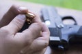 Loading Handgun Magazine. Bullets and Pistol Background. Charging Gun. Royalty Free Stock Photo