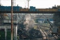 Loading iron ore in container by bucket on metallurgy heavy industry outdoor