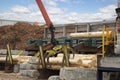 Loading logs onto a logging truck. Portable crane on a logging truck