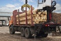 Loading logs onto a logging truck. Portable crane on a logging truck Royalty Free Stock Photo