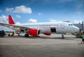 Loading luggage into the luggage compartment.The plane is on the platform of the airport. Blue sky. Travel. Flights by air. Runway Royalty Free Stock Photo