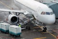 Loading luggage into the plane. Special equipment at the airport. Royalty Free Stock Photo