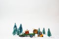 A miniature truck with Christmas gifts with a forklift in a snowy landscape