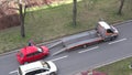 Loading of the red car Skoda Fabia onto 1220 Global Assistance towing truck