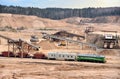 Loading sand into freight cars of a train in quarry. Sand Making Plant in open-pit mining. Crushing factory, machines and