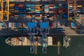 Loading and unloading a container ship in the port at the pier Royalty Free Stock Photo