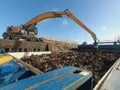 A loading and unloading crane unloads metal and metal waste from the ship`s hold