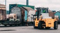 Loading and unloading process of steel coils in cargo port. Carry steel coils. Lifter take coil from wagon. Stevedor are checking