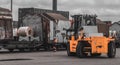 Loading and unloading process of steel coils in cargo port. Carry steel coils. Lifter take coil from wagon. Stevedor are checking