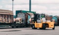 Loading and unloading process of steel coils in cargo port. Carry steel coils. Lifter take coil from wagon. Stevedor are checking