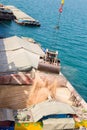 Loading wheat on cargo ship with crane and bucket. Shipment from a merchant ship to a small ship. Grapple crane fill wheat into