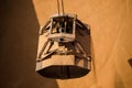 Loading wheat on cargo ship with crane and bucket. Shipment from a merchant ship to a small ship. Grapple crane fill wheat into