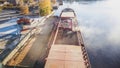 Loading wheat grain into barge, port and food industry grain silos in the port of Ukraine