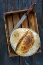 Loaf of artisanal sourdough bread and a knife. Royalty Free Stock Photo