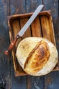 Loaf of artisanal sourdough bread and a knife. Royalty Free Stock Photo