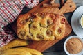 Loaf of banana bread on a wooden cutting board with cup of tea on rustic wooden table Royalty Free Stock Photo