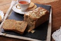 Loaf Banana Nut Sweet Bread Sliced on a Slate Plate, Served with Tea Royalty Free Stock Photo