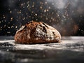 A loaf of bread is being sprinkled with flour