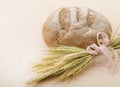 A loaf of bread and a bunch of wheat ears Royalty Free Stock Photo