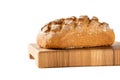 loaf of bread on cutting board, isolated on white Royalty Free Stock Photo