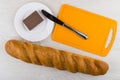 Loaf of bread, cutting board, knife and chocolate butter Royalty Free Stock Photo