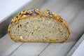 Loaf of bread with edible flowers and nuts Royalty Free Stock Photo