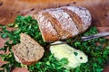 Loaf of bread, knife and Easter lamb made of butter on a wooden table Royalty Free Stock Photo