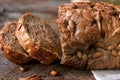 A loaf of bread on paper lies on a wooden table