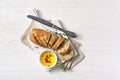 Loaf of bread with spicy olive oil and silver knife Royalty Free Stock Photo