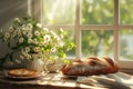 loaf of bread on the table, pies on a plate nearby and flowers by the blur window on a sunny day Royalty Free Stock Photo