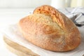 Loaf of delicious bread on white wooden table, closeup Royalty Free Stock Photo