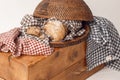 Loaf of fresh homemade french bread in bread rattan basket with kitchen linen check towels on solid wood stamp. Royalty Free Stock Photo