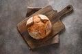 Loaf of freshly baked bread on brown background. Royalty Free Stock Photo