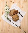 Loaf of freshly baked homemade rye bread cut into slices with a knife on a wooden table Royalty Free Stock Photo