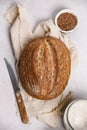 Loaf of freshly baked homemade sourdough bread on linen towel, top view Royalty Free Stock Photo