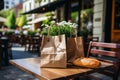 A loaf of freshly baked wheat bread and a craft paper bag lie on the table of a street cafe, bakery and confectionery Royalty Free Stock Photo