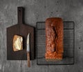 Loaf of home baked banana bread, one slice buttered. Top view Royalty Free Stock Photo