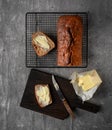 Loaf of home baked banana bread, two slices buttered. Top view Royalty Free Stock Photo