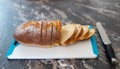 Loaf of homemade artisan wheat bread, partially sliced, on cutting board Royalty Free Stock Photo