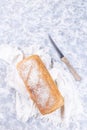 Loaf of homemade no knead sandwich bread with knife, vertical, top view, copy space Royalty Free Stock Photo