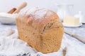 Loaf of homemade no knead sandwich bread with white cloth, horizontal