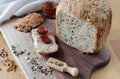 loaf of homemade whole grain bread and a cut off slice of bread. A mixture of seeds and whole grains. healthy eating Royalty Free Stock Photo