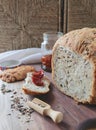 loaf of homemade whole grain bread and a cut slice of bread on a wooden cutting board. A mixture of seeds and whole Royalty Free Stock Photo