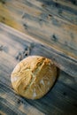 Loaf of light bread lies below on a wooden table. Top view Royalty Free Stock Photo