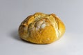 Loaf of round French bread on a light background