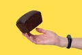 Loaf of rye bread, balanced on a hand with fitness band. Concept of sustainable consumption and healthy nutririon